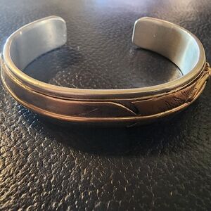 SOLD. Sterling silver cuff bracelet w/ gold filled feather decorative detailing.